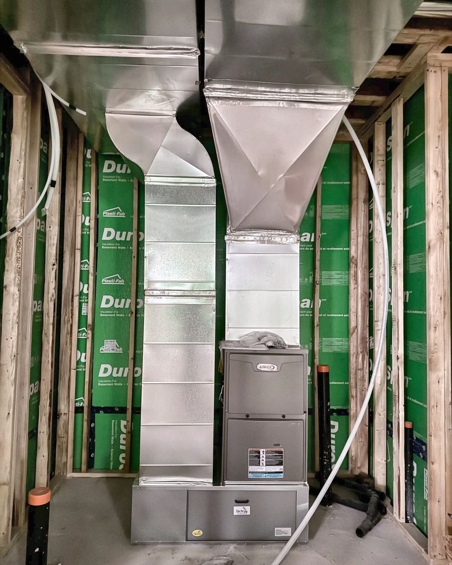 Furnace with supply and return trunks in an insulated new-build basement